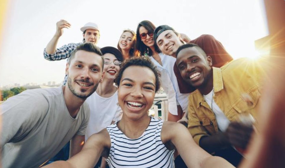 A group of friends laughing together in a selfie