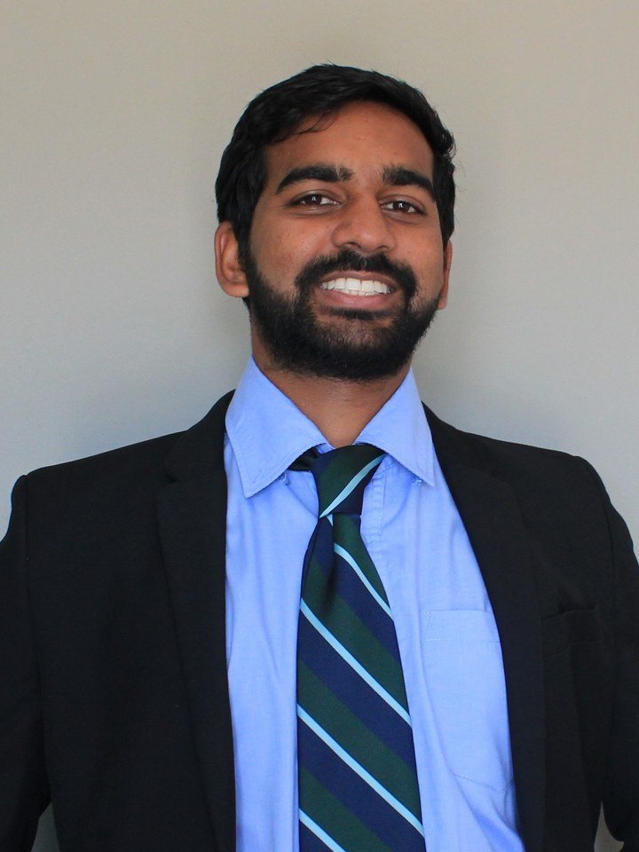 Sheik in a jacket and tie, smiling