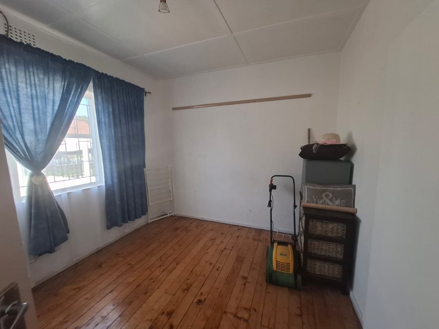 The bedroom with wooden floors and blue curtains